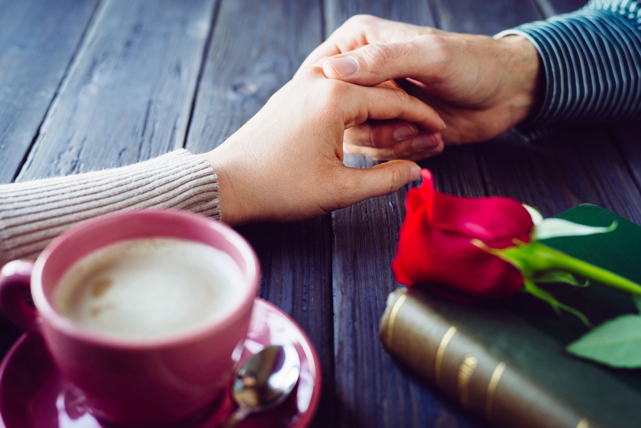 Hands outstretched across table touching