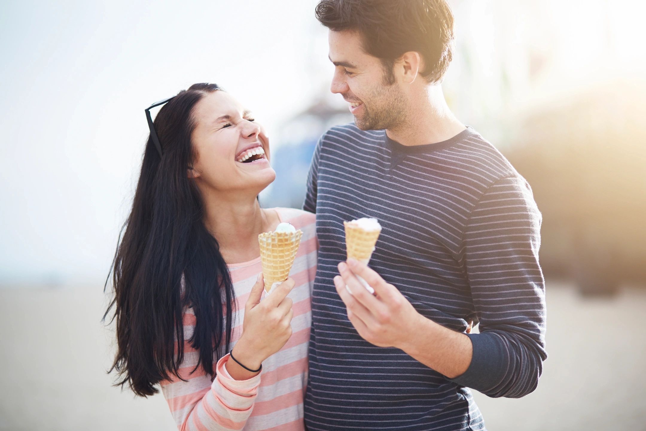 Happy couple eating ice cream cones