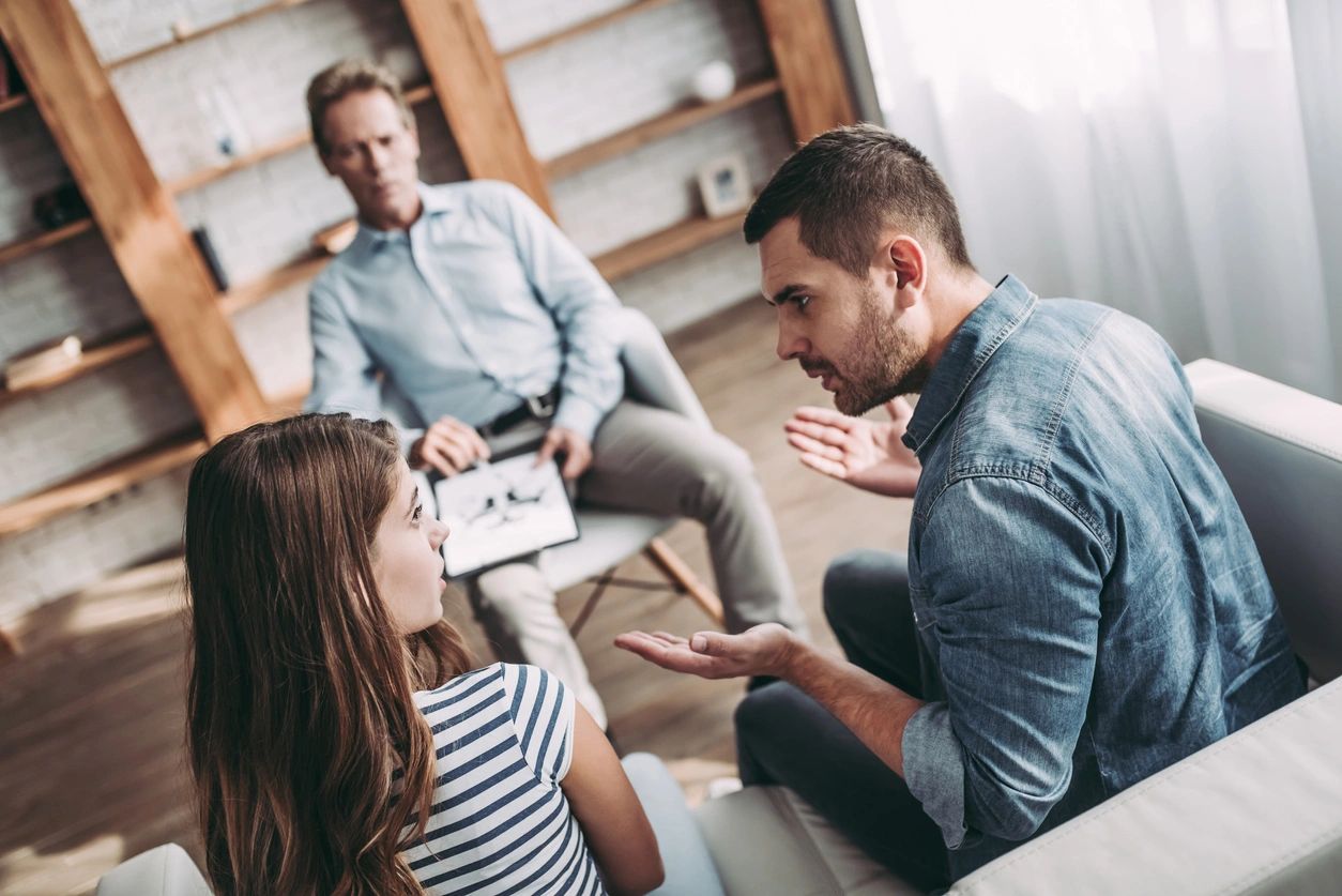 Couple arguing in front of counselor